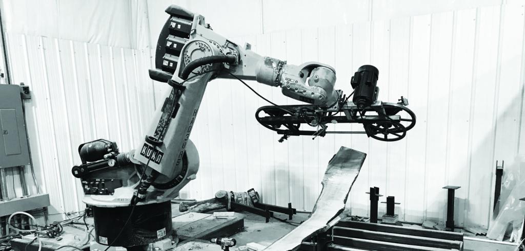 black and white image of a machine milling a log