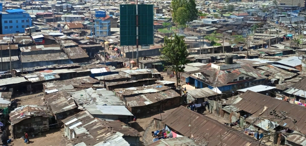An aerial photograph of slums with a few modern building elements 