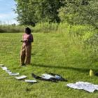 Image Text M.F.A. student working on art project at the Soil Factory in Ithaca, New York, in summer 2023.