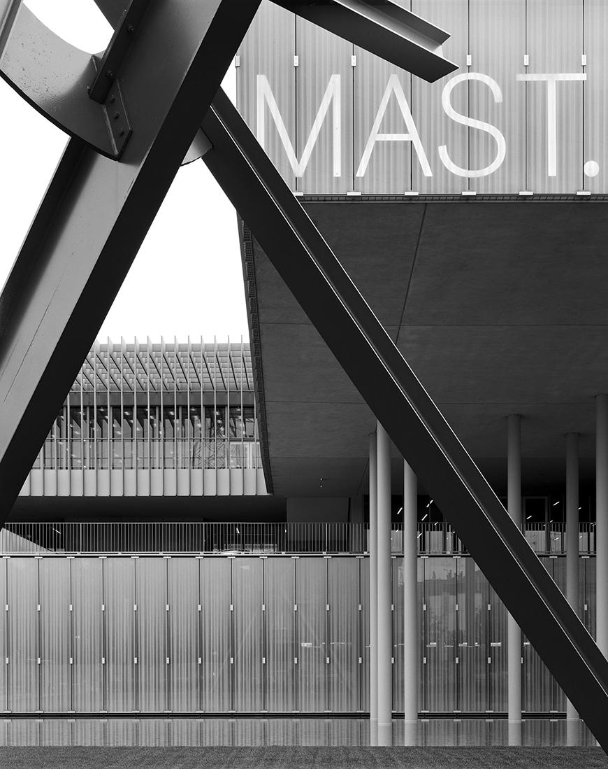 sculpture in front of modern buildingin black and white 