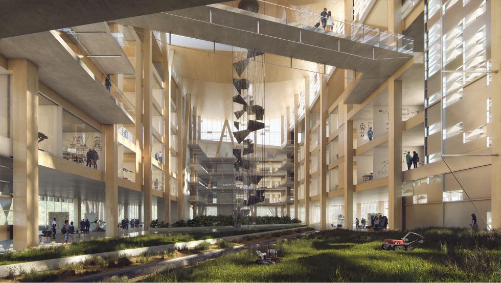 The image shows the inside of a large, modern building with tall wooden beams and concrete floors. There are several levels connected by walkways, and in the center hangs a unique vertical sculpture. The ground floor features a green area with grass and plants, blending nature with the sleek architecture. People are seen throughout the space, possibly working or studying, giving the building a lively and open atmosphere.