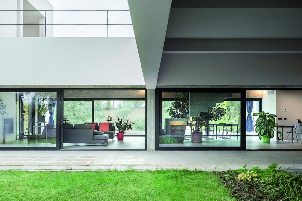 Building featuring large glass walls as viewed from the lawn in front