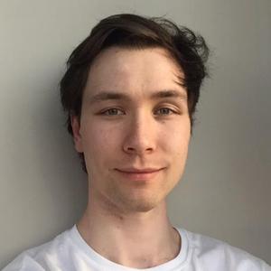 headshot of young man with brown hair wearing a white t-shirt